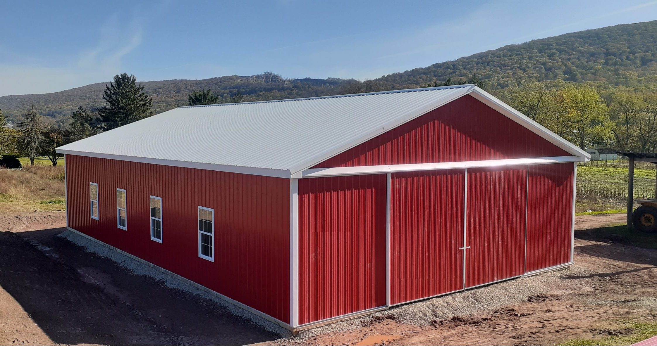 Red and white horse pole barn
