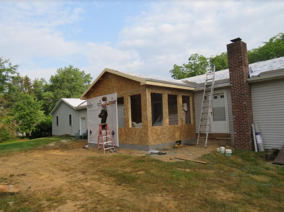 Jm riehl employee adding framing and attachments to home addition project
