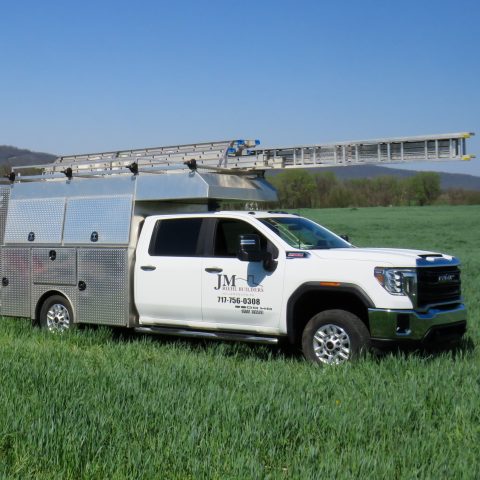 JM Riehl white pickup with a white trailer